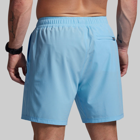 Light blue shorts worn by a person on a plain background