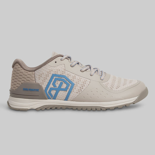 Beige and gray athletic shoe with a blue logo on a gray background
