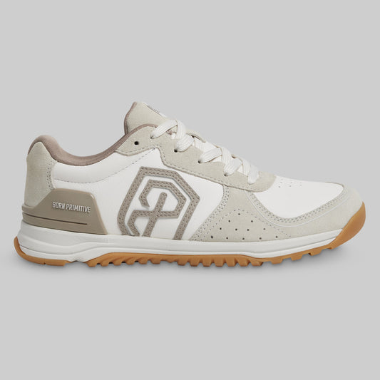 White and beige sneaker with a distinctive logo on a gray background