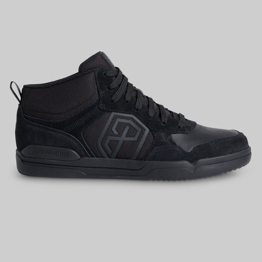 A black mid-top sneaker with a textured mesh and suede upper, featuring a large geometric logo on the side and a pull tab on the heel, shown against a solid gray background.