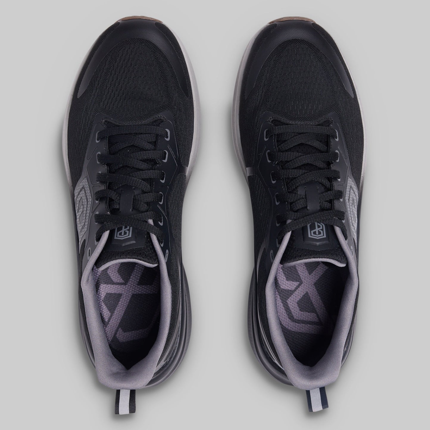 Black and gray athletic shoes on a light gray background