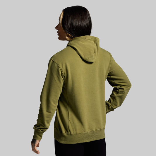 Person wearing a green hoodie on a gray background