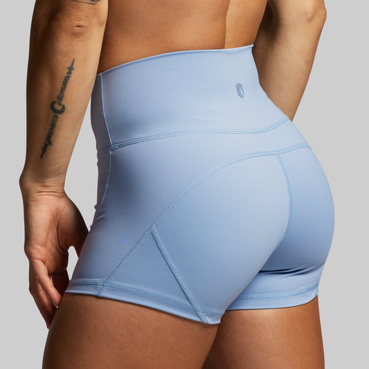 Light blue athletic shorts worn by a person on a gray background