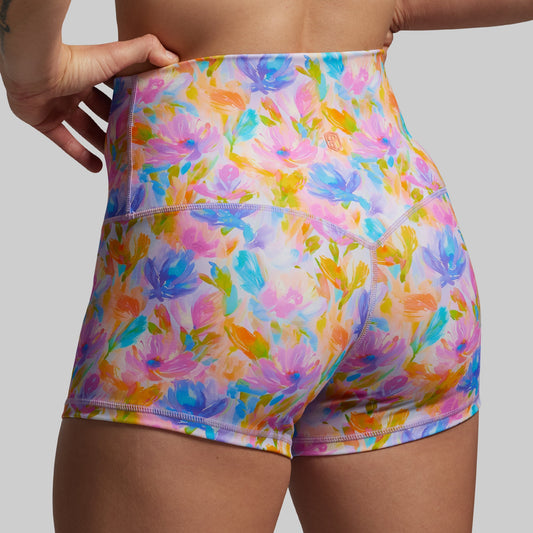 Colorful floral shorts worn by a person on a neutral background