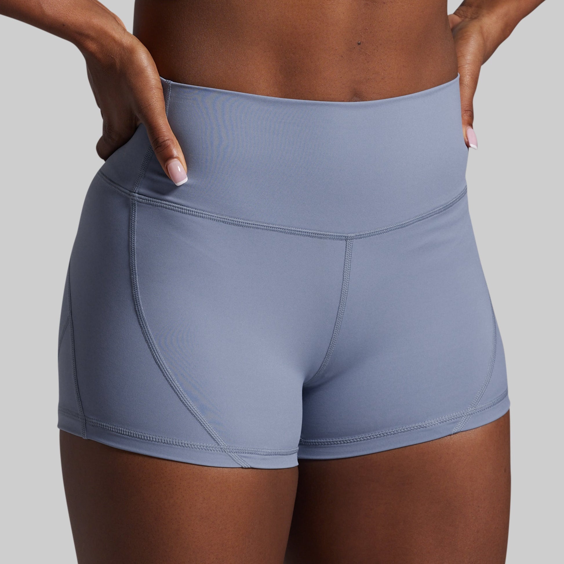 Gray athletic shorts worn by a person on a gray background
