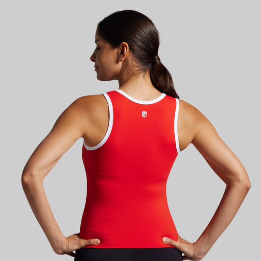 Woman wearing a red tank top with a logo on a gray background
