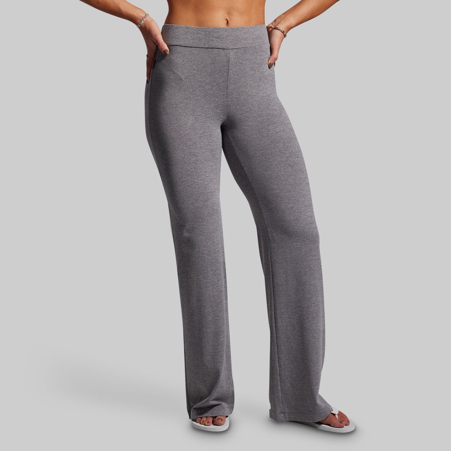 Gray pants worn by a person on a plain background