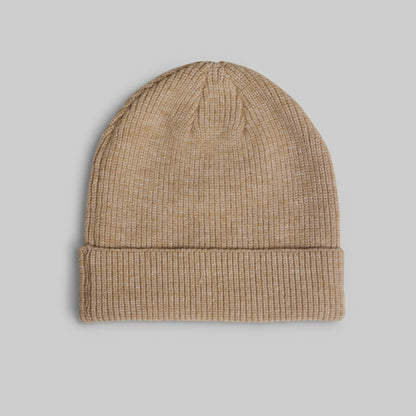 A classic ribbed knit beanie hat in a heathered tan or camel color, presented flat against a solid light gray background.