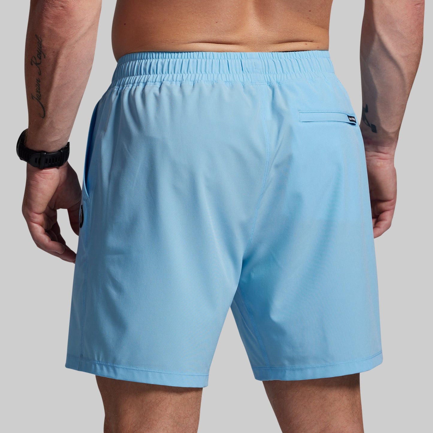 Light blue shorts worn by a person on a plain background