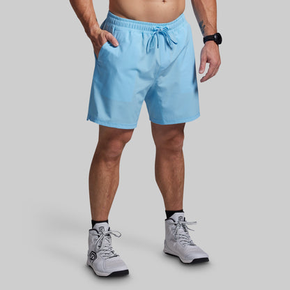 Person wearing light blue shorts on a gray background