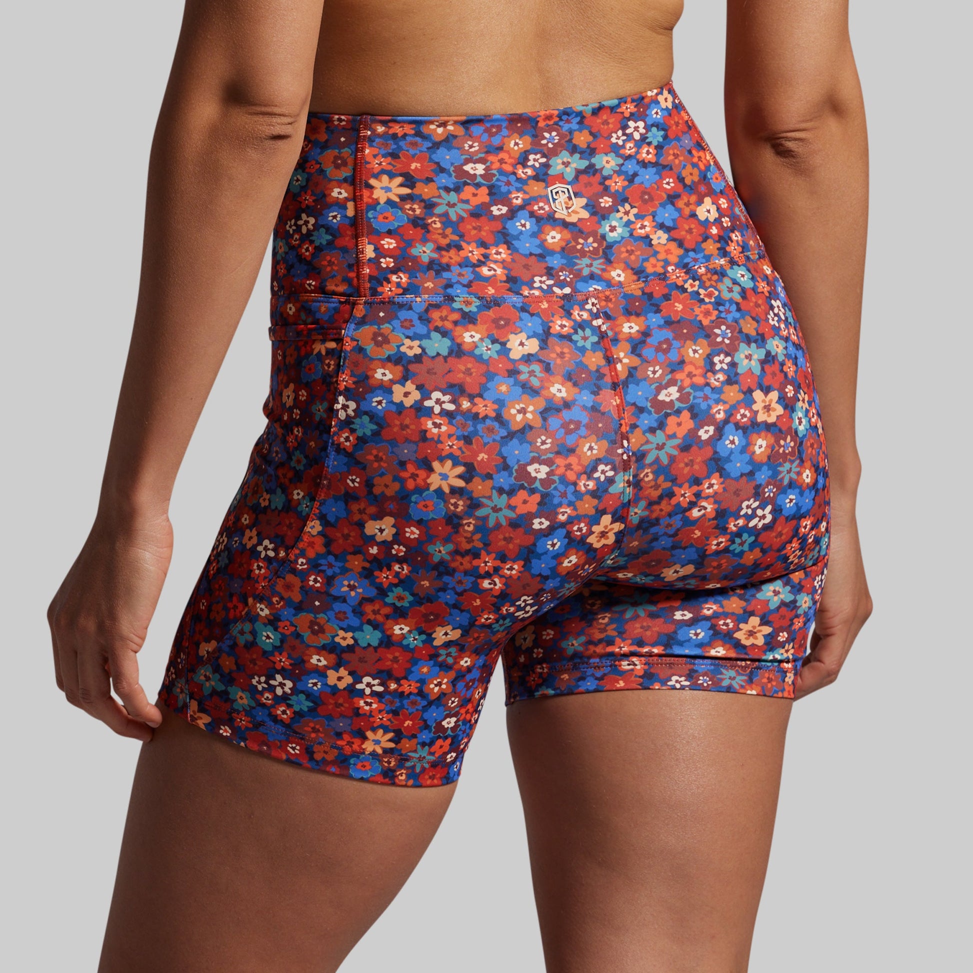 Floral patterned shorts worn by a person on a plain background
