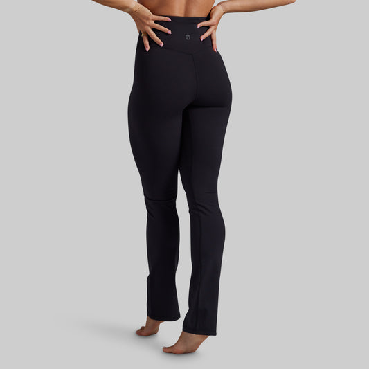 Black high-waisted ankle-length yoga pants shown on a model from the back.
