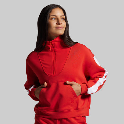 Person wearing a red sweater with white stripes on a gray background