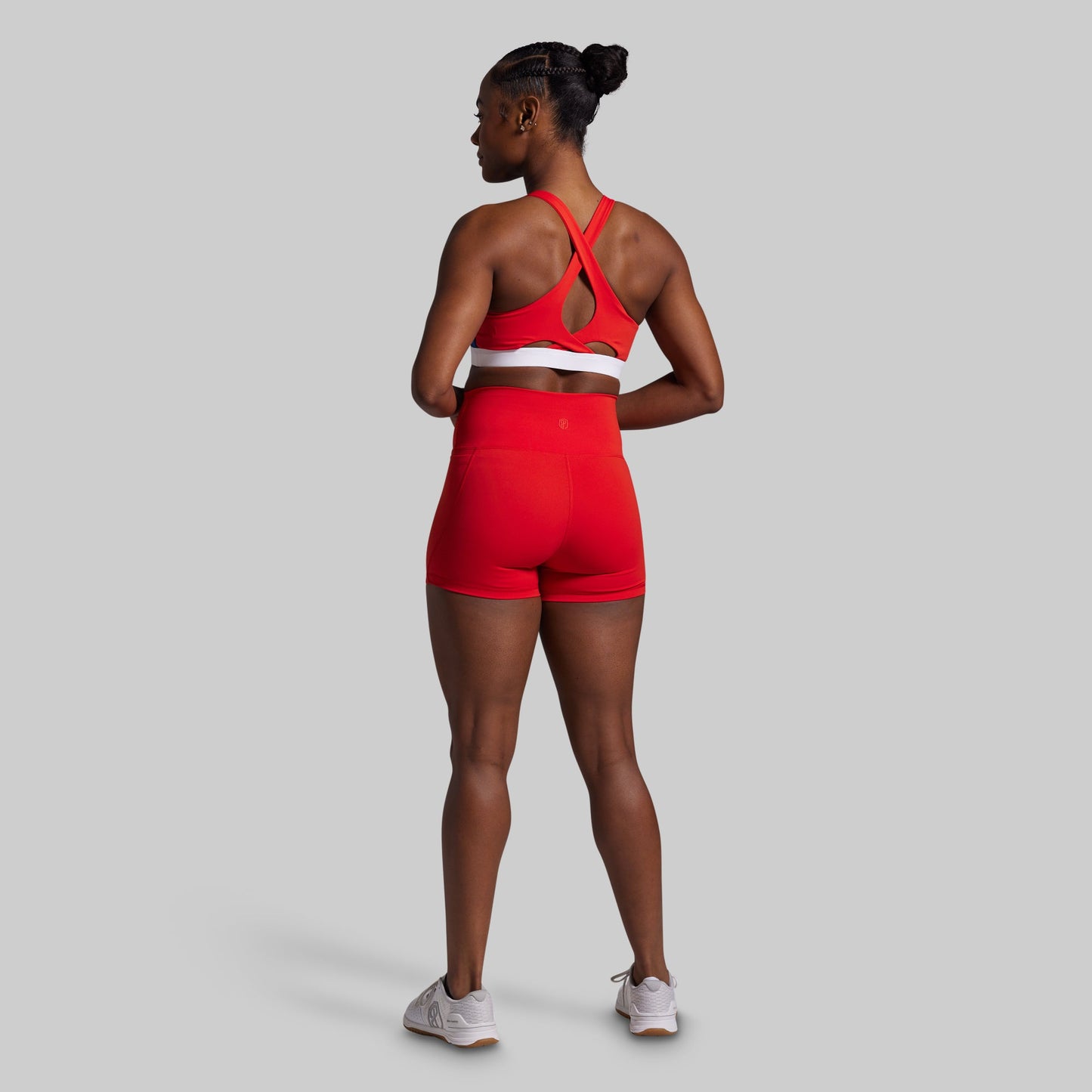 Person wearing a red sports outfit on a gray background