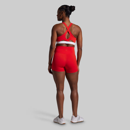 Person wearing a red athletic outfit on a gray background