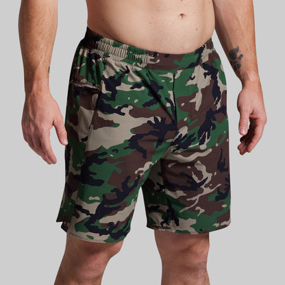 Camouflage shorts worn by a person on a plain background