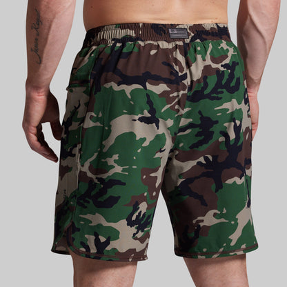 Camouflage shorts worn by a person on a plain background