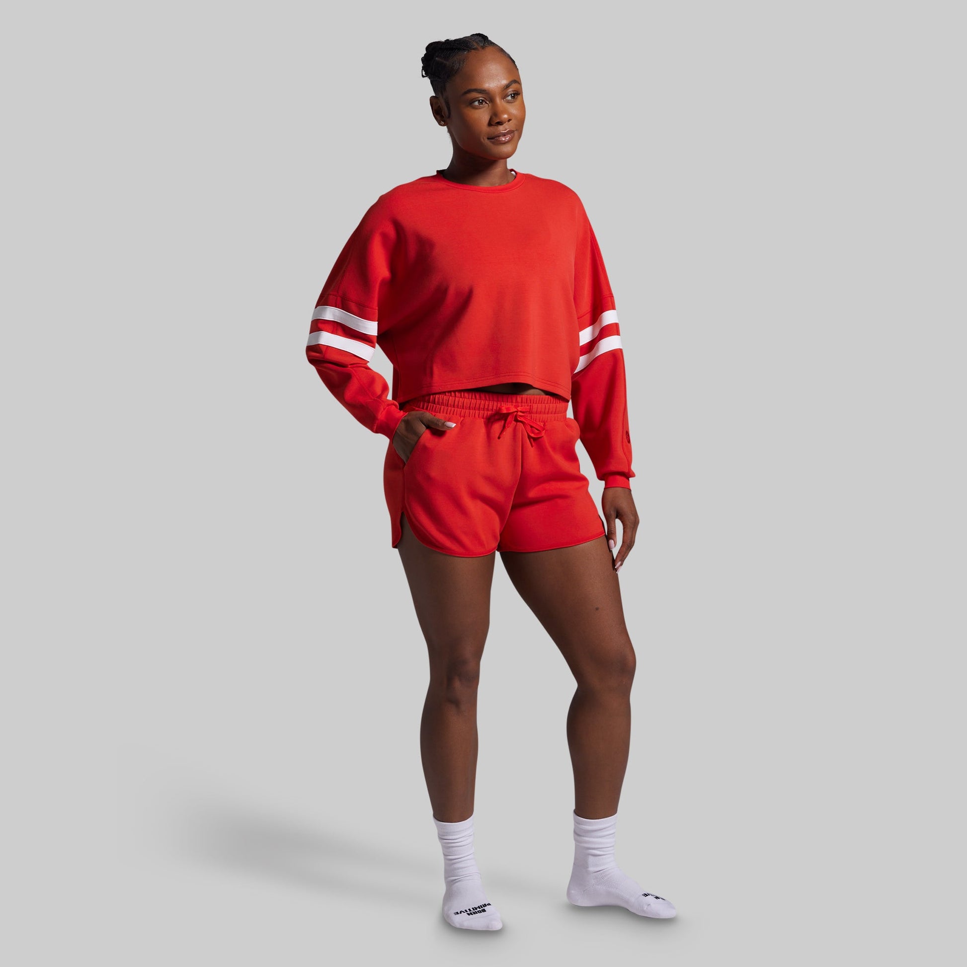 Person wearing a red outfit with white stripes on a gray background