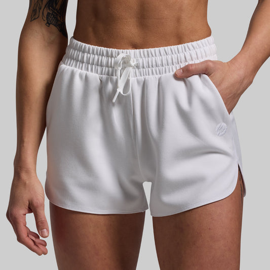 White shorts worn by a person on a plain background