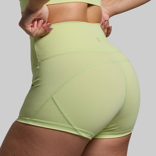Light green athletic shorts worn by a person on a plain background