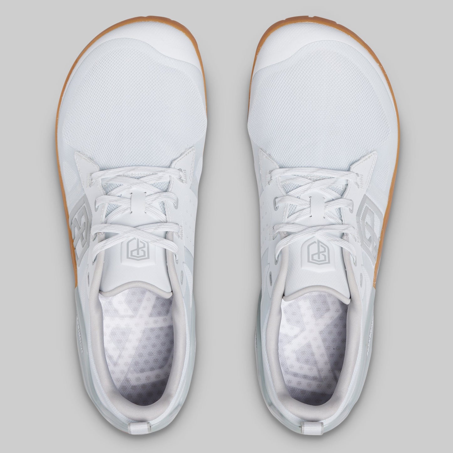 A pair of white low-top athletic sneakers shown from a top-down view on a light gray background.
