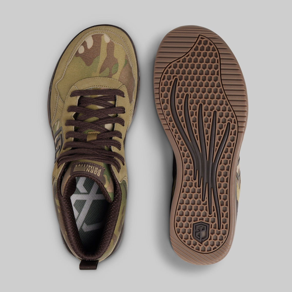 A pair of sneakers shown from the top and bottom. The upper features a green, brown, and tan camouflage pattern with dark brown laces, while the sole is a textured brown rubber with a black tread pattern.