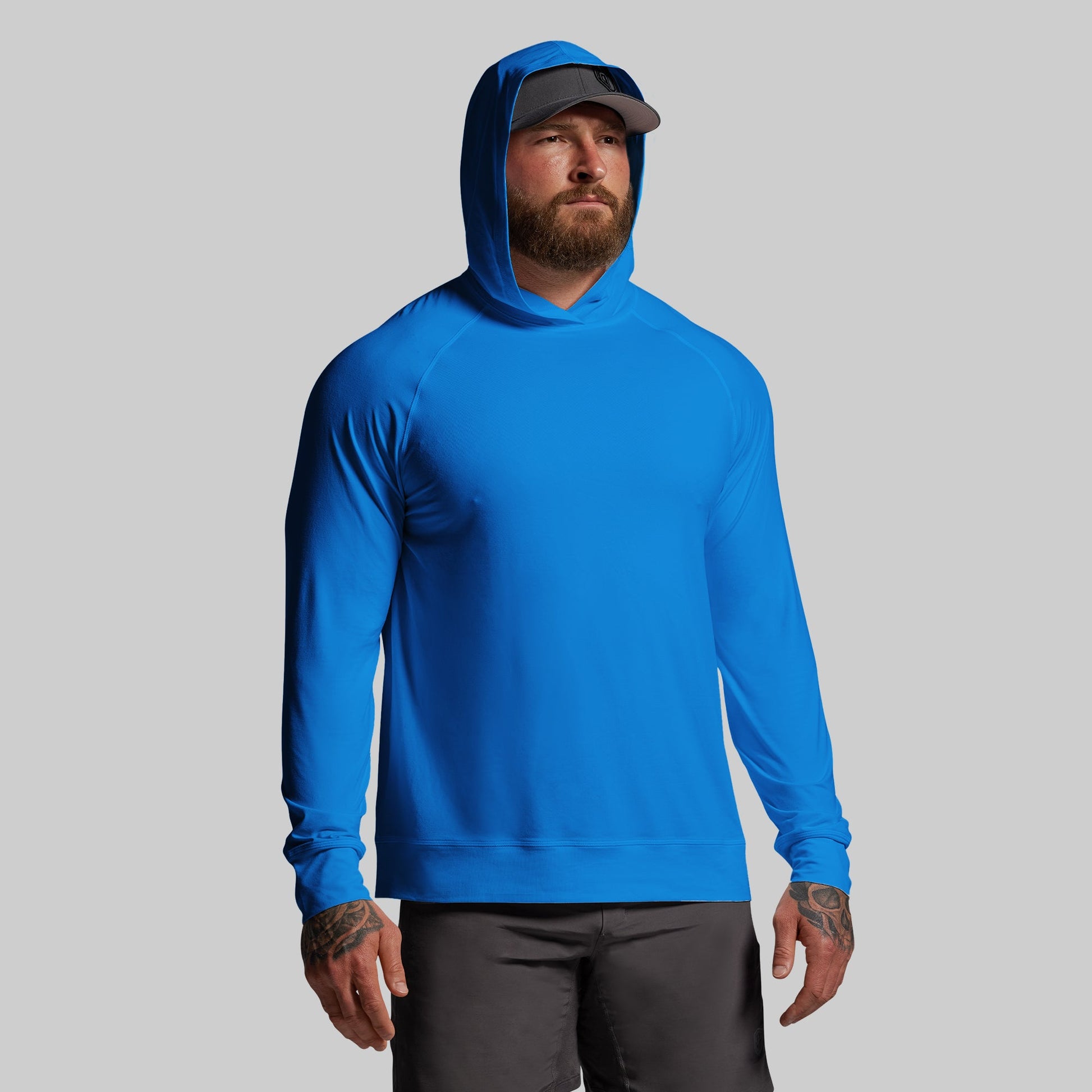Man wearing a blue hoodie on a gray background