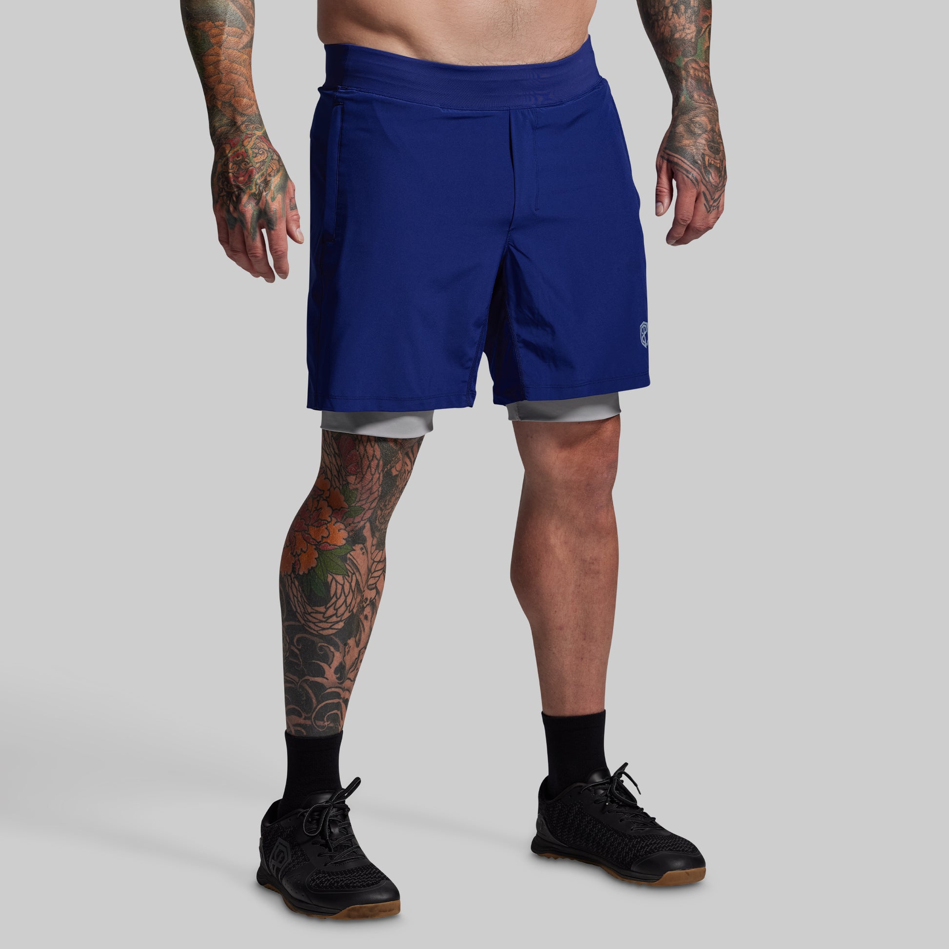 Person wearing blue shorts on a gray background