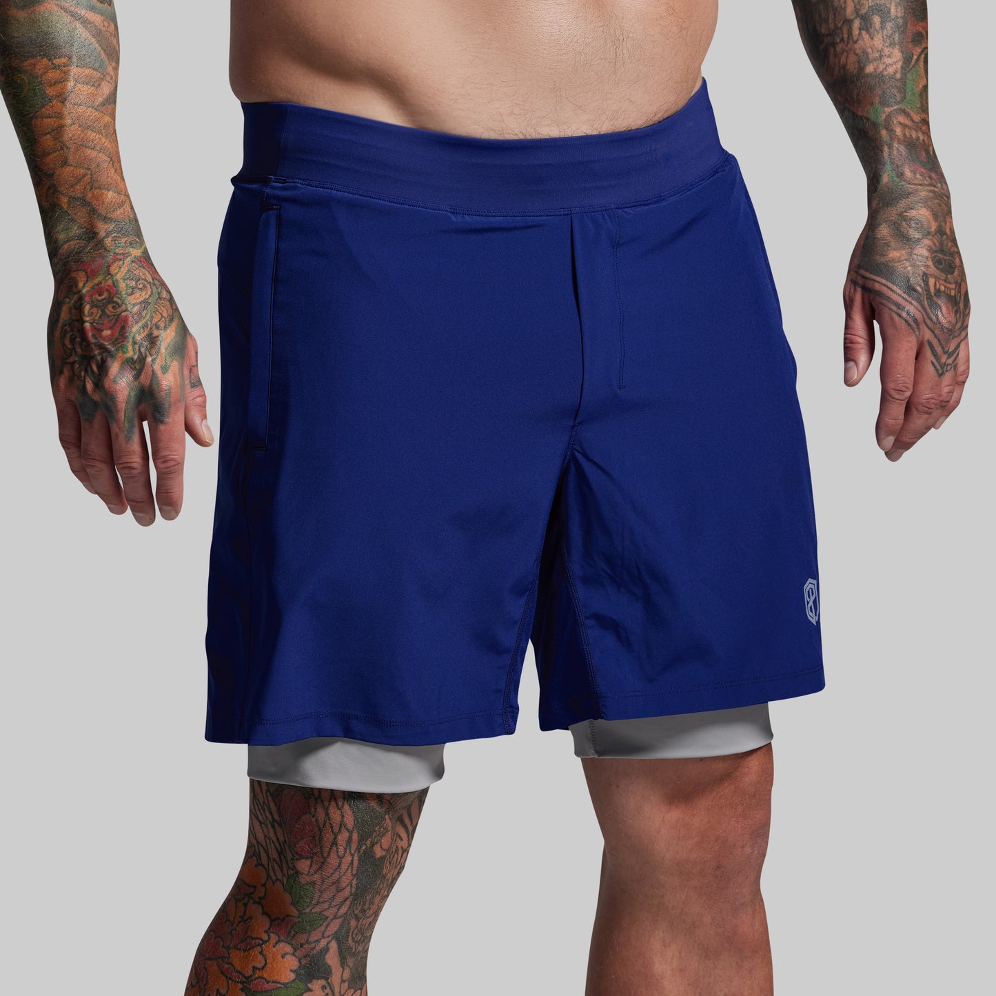 Person wearing blue shorts on a gray background