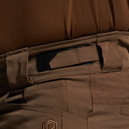 Close-up of brown tactical pants with a visible brand logo.