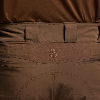 Close-up of brown tactical pants with a visible brand logo on the waistband.