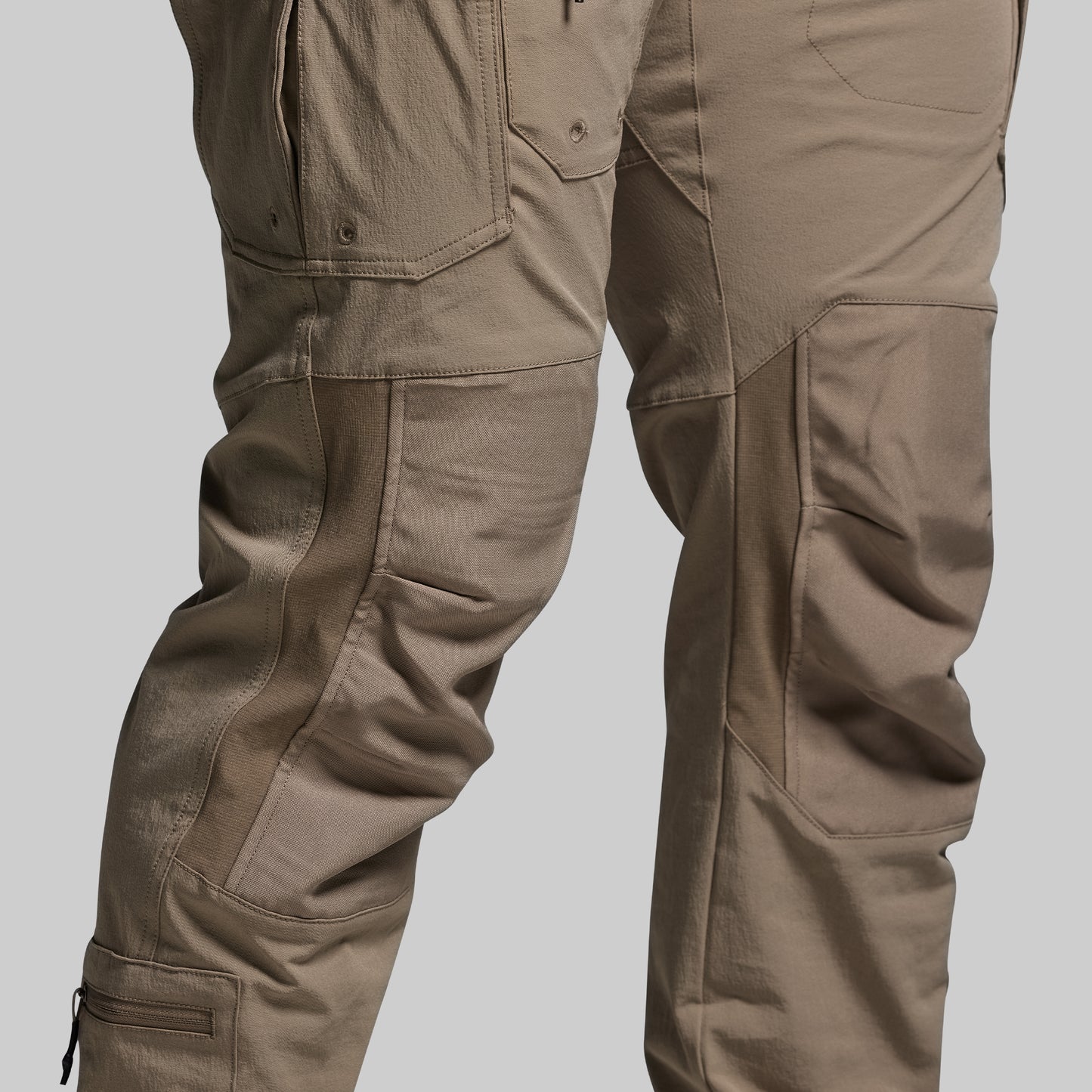 Close-up of brown tactical pants on a light gray background