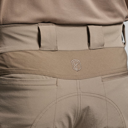 Close-up of beige tactical pants with a visible brand logo.