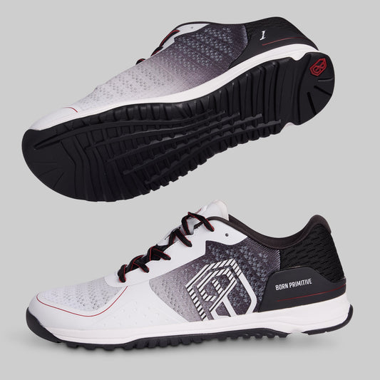 White and black athletic shoes with a visible brand logo on a gray background
