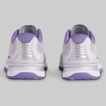 White and purple athletic shoes on a gray background