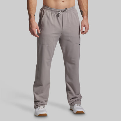 Man wearing gray pants on a plain background