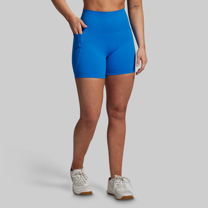 Person wearing blue athletic shorts on a gray background