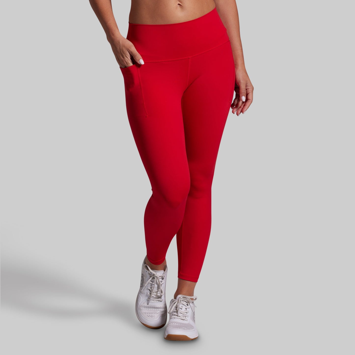 Red leggings worn by a person on a gray background