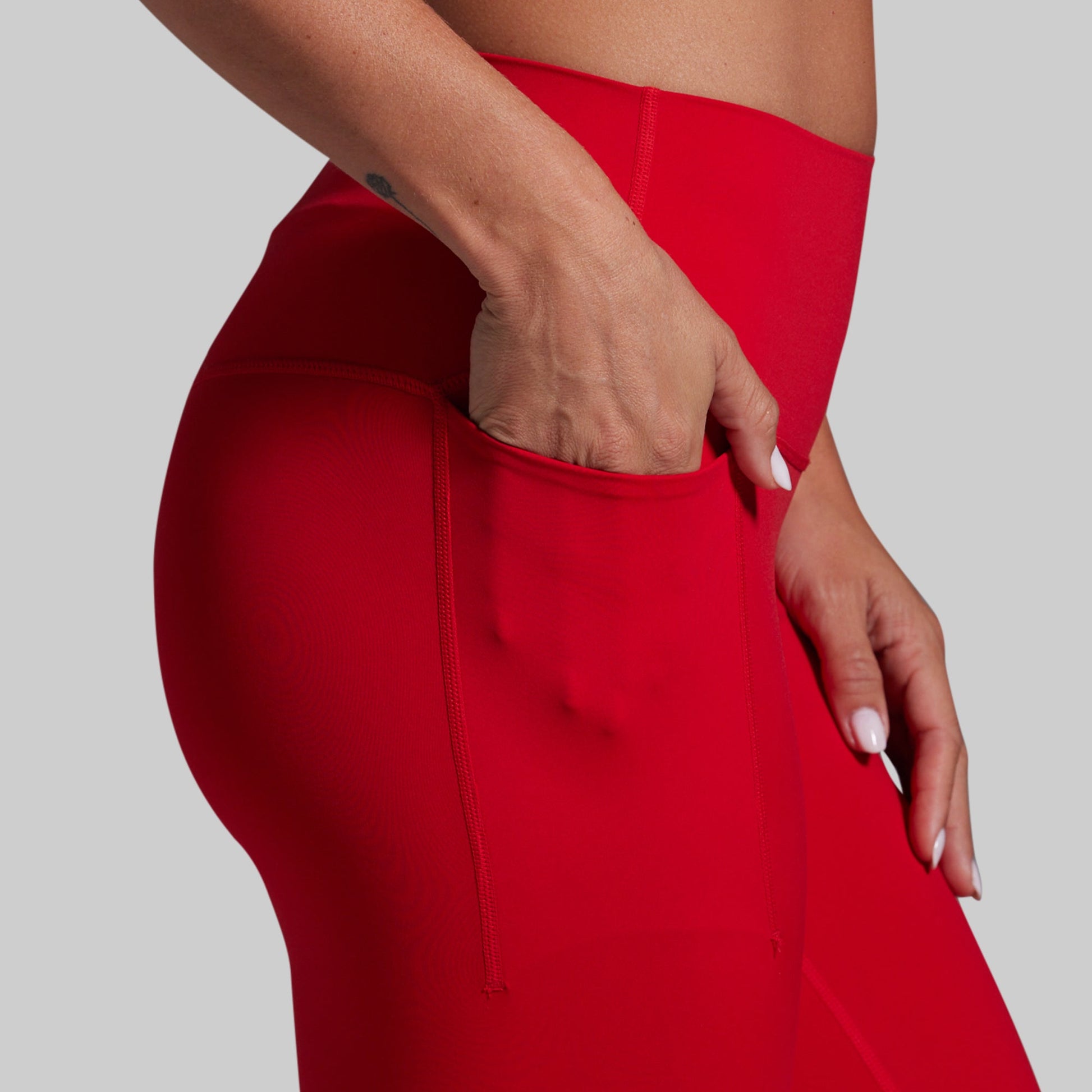 Red leggings worn by a person on a plain background