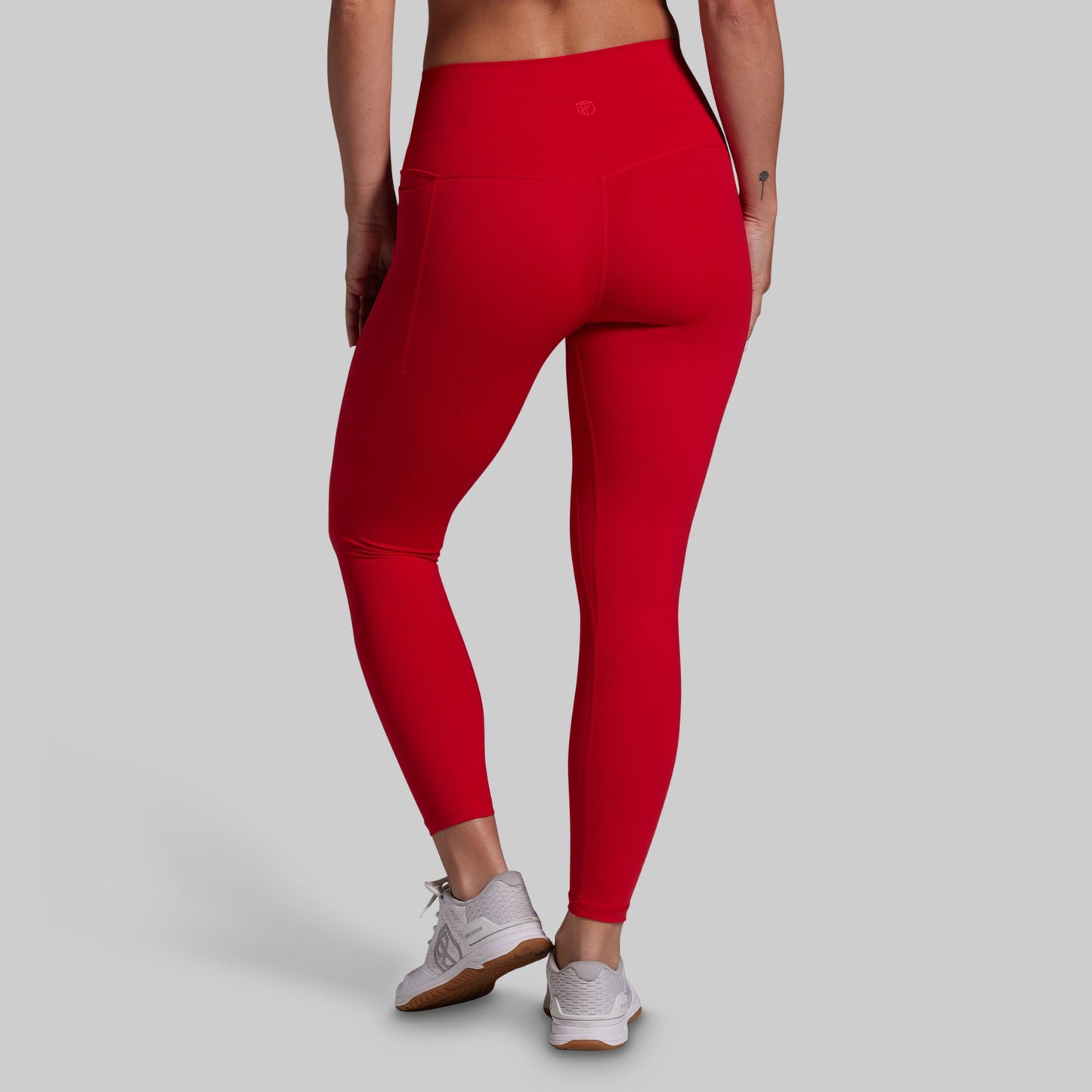 Red leggings worn by a person on a gray background