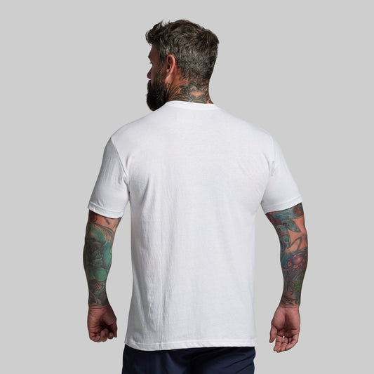 Man wearing a plain white t-shirt against a gray background