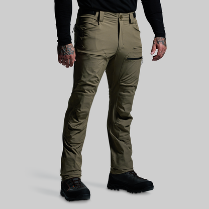 Person wearing olive green pants on a gray background