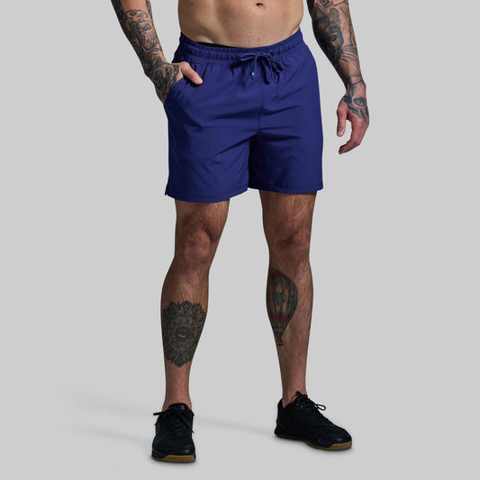 Person wearing blue shorts on a gray background