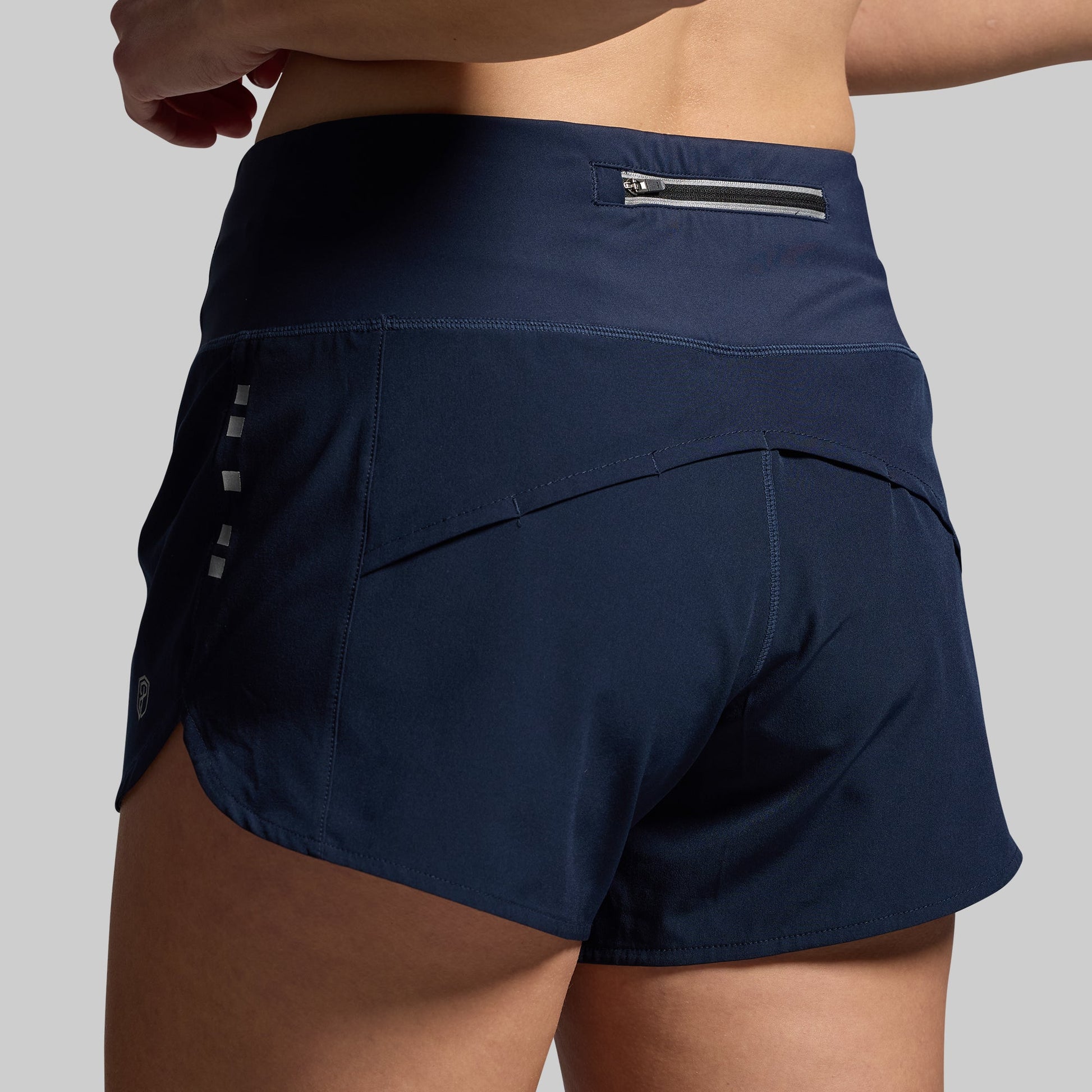 Navy blue athletic shorts with a gray background
