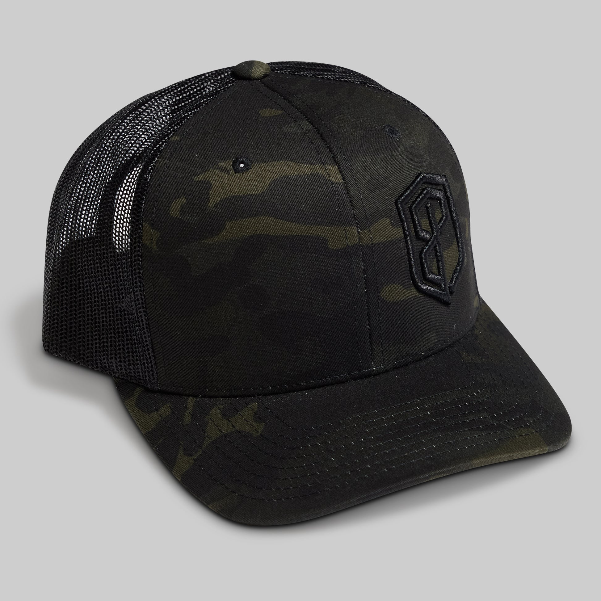Camouflage trucker hat with a logo on a gray background