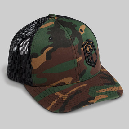 Camouflage baseball cap with black mesh back on a gray background