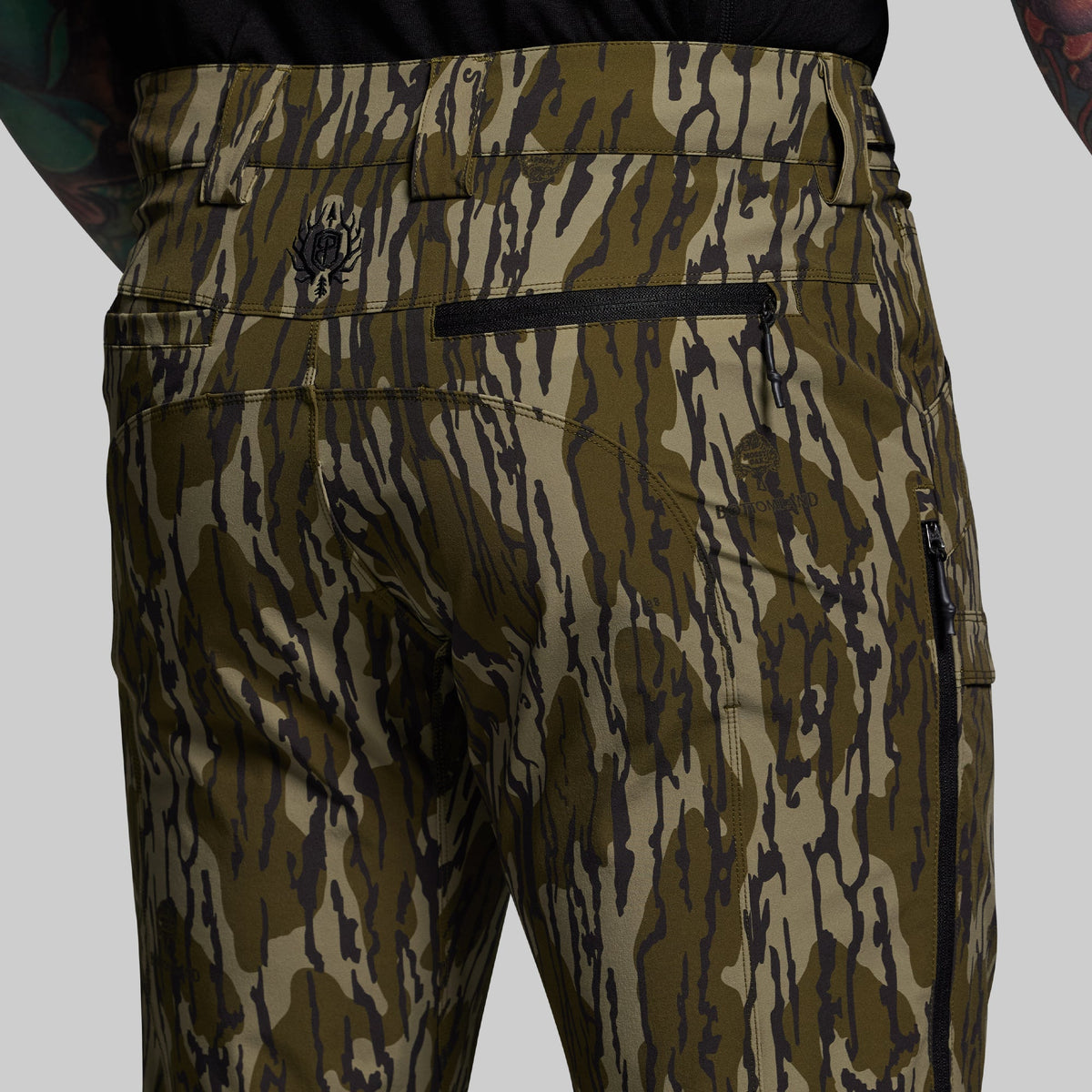Camouflage pants with a brand logo on a gray background
