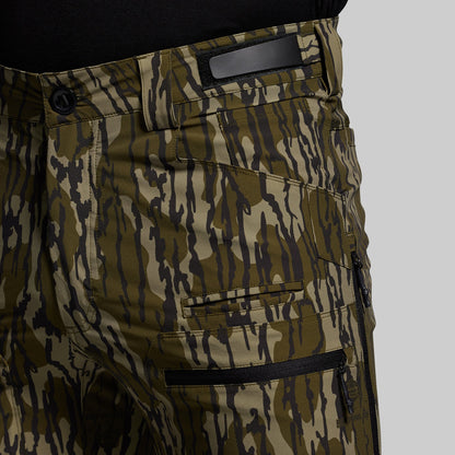 Camouflage pants with multiple pockets on a gray background