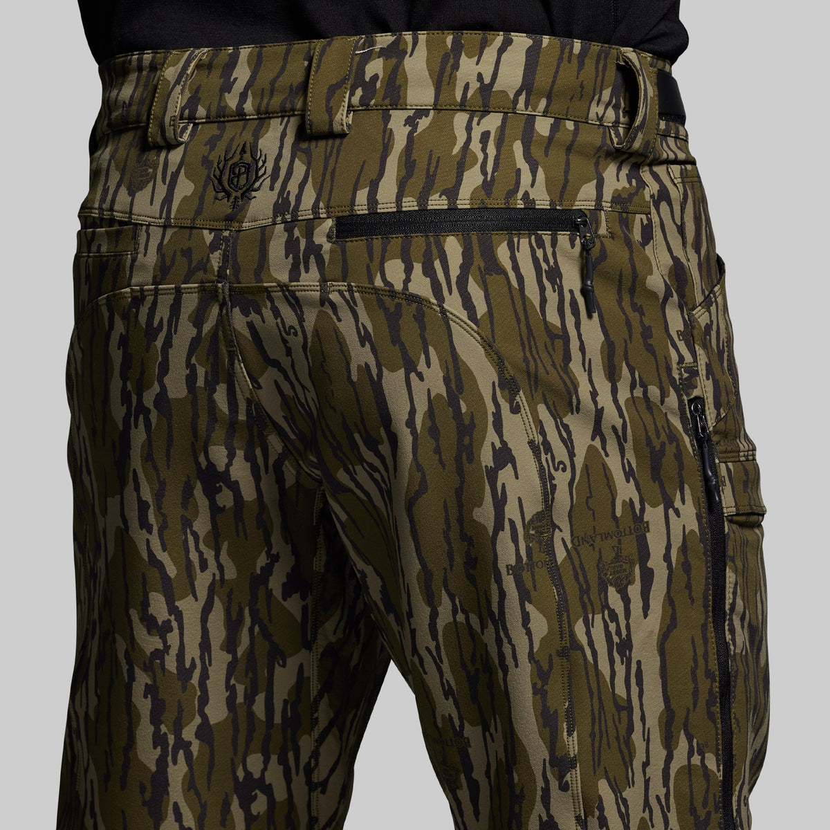 Camouflage pants with a brand logo on a gray background