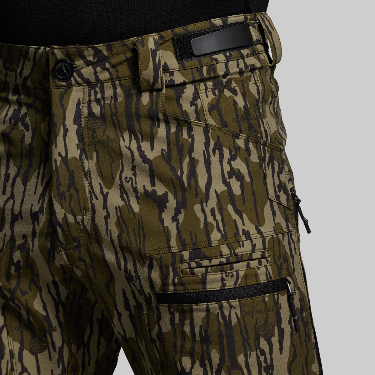 Camouflage pants with zippers on a gray background